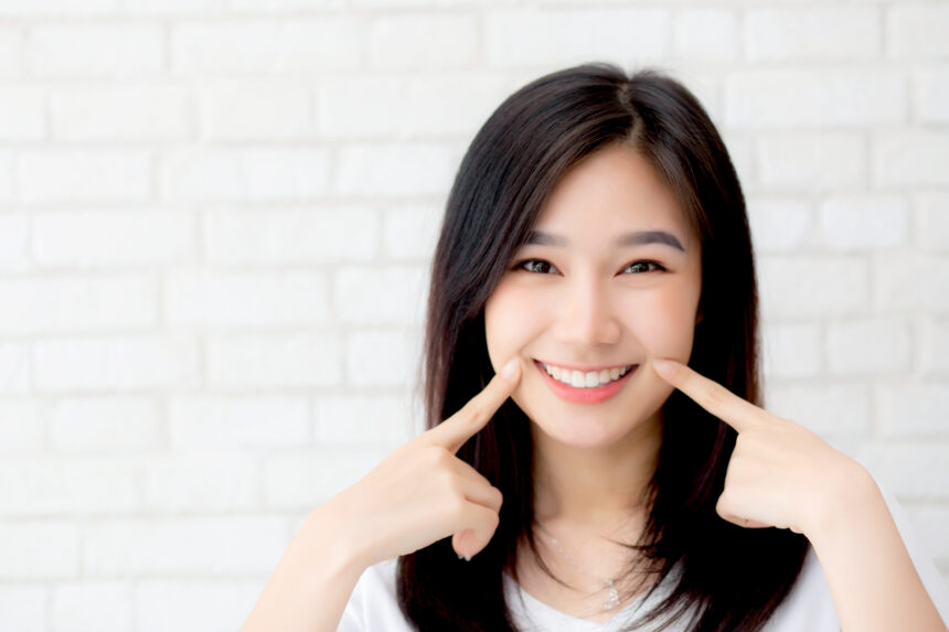 Portrait of beautiful young asian woman happiness standing finge